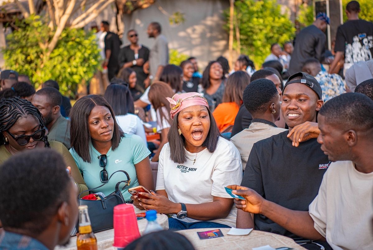 Diverse group of young people celebrating together, representing the youth empowerment mission of Uplifters